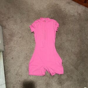 This is a bright pink romper in a size medium in women's.